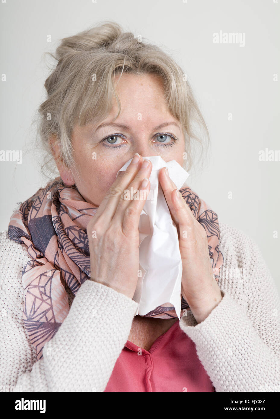 elderly woman with a handkerchief brushing her nose Stock Photo