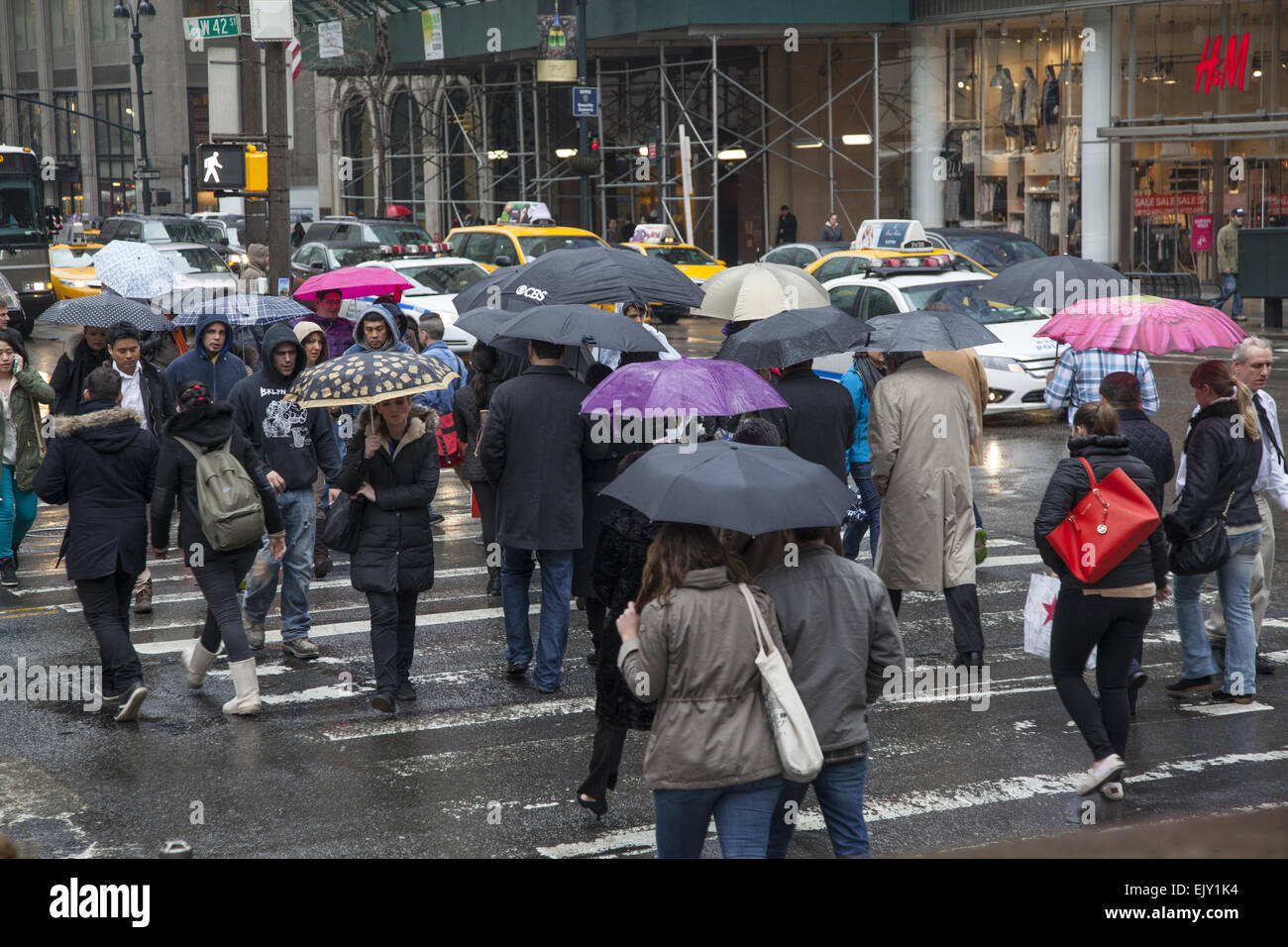 42nd  St. & 5th Avenue  in midtown Manhattan is always busy rain or shine. Stock Photo