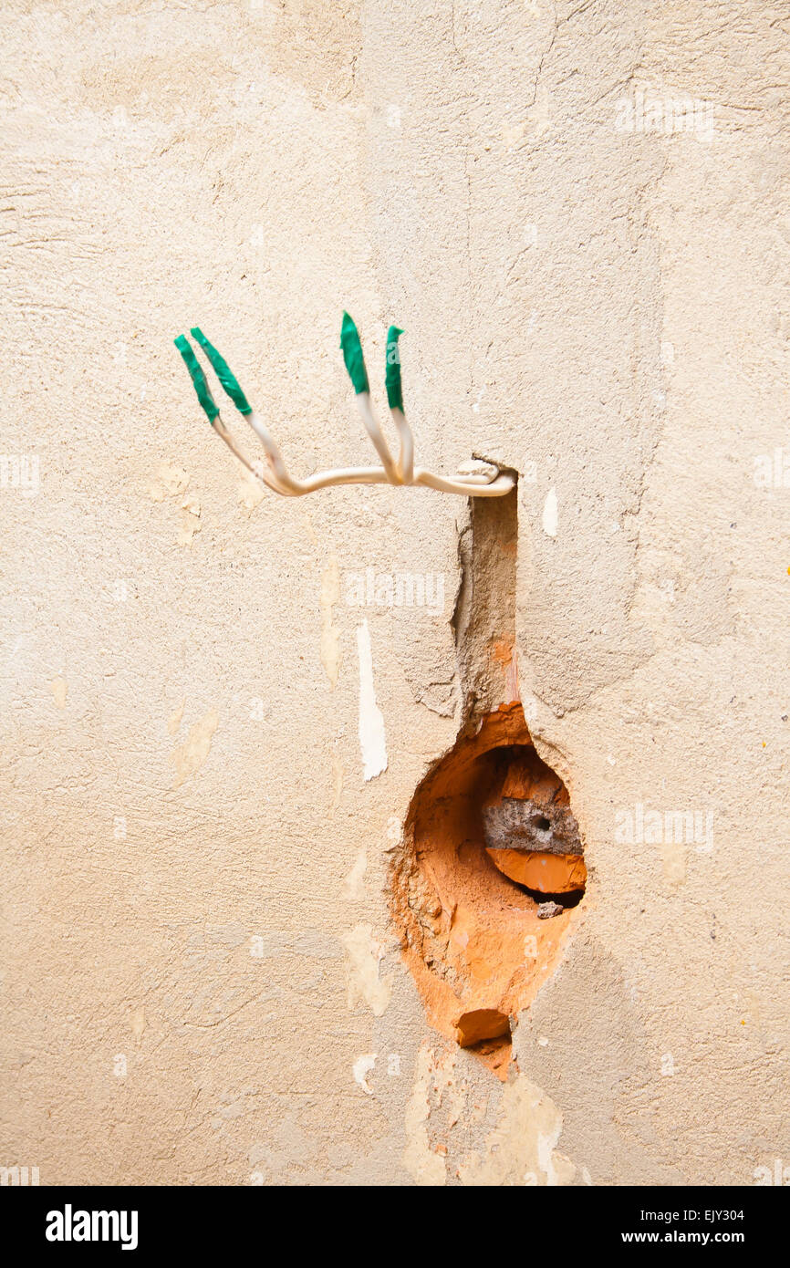 Undone AC power socket in wall. Repairs in the apartment. Stock Photo