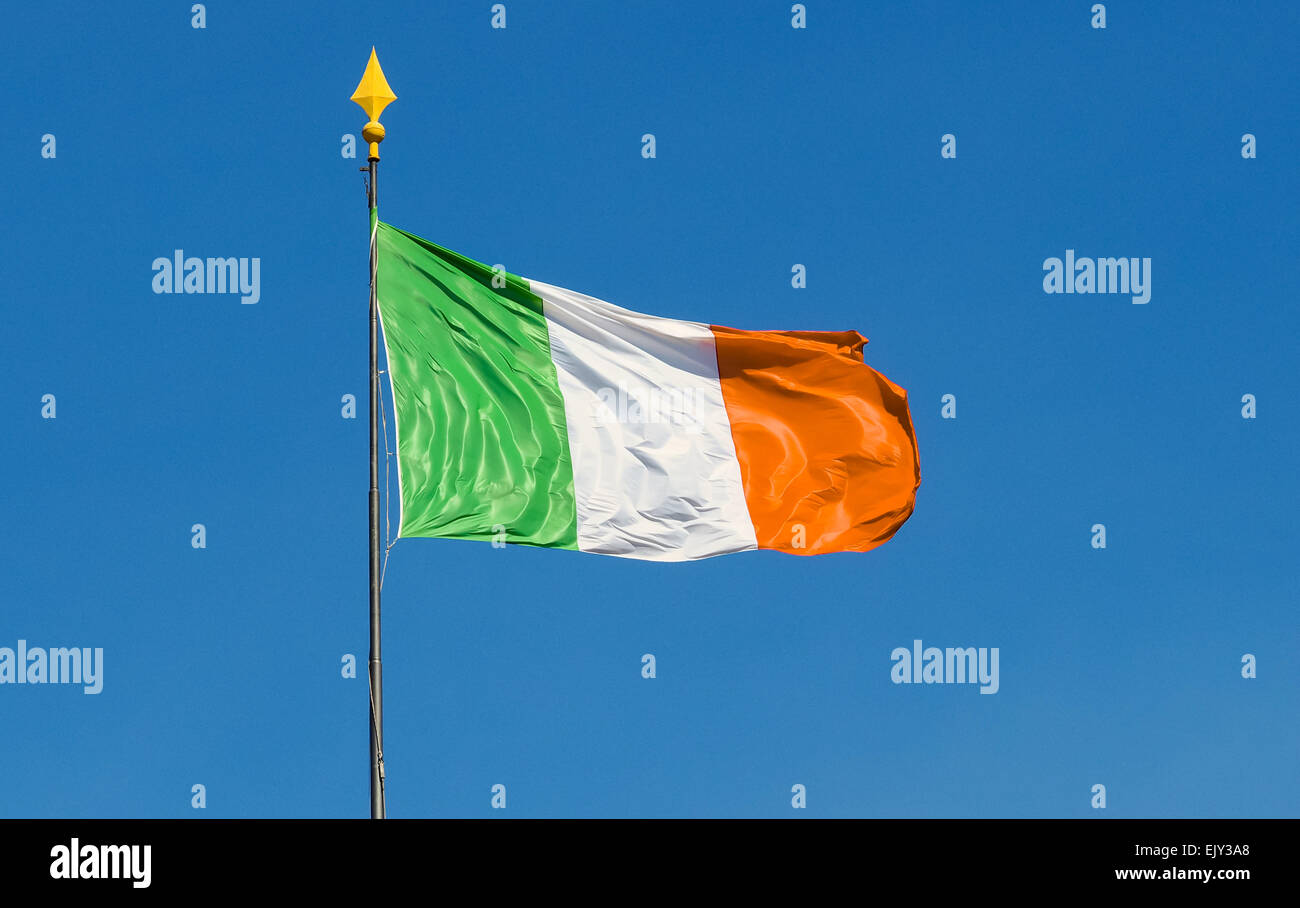 Flag of Ireland waving in a sunny day with clear blue sky in the background, useful wor copy space Stock Photo