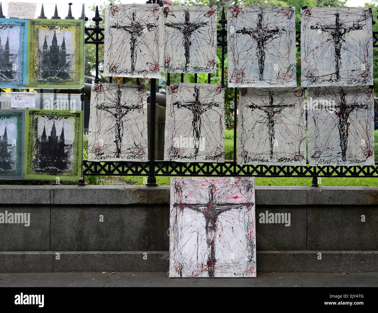 silkscreen art crucifixion scene christ religious iconography for sale sell selling outdoors railings jackson square new orleans Stock Photo