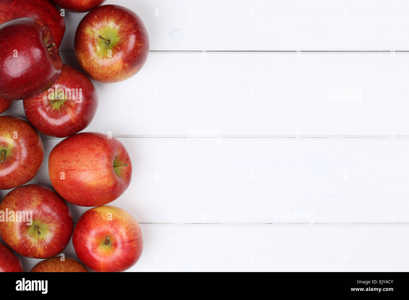Red apple fruits background on a wooden board with copyspace Stock Photo