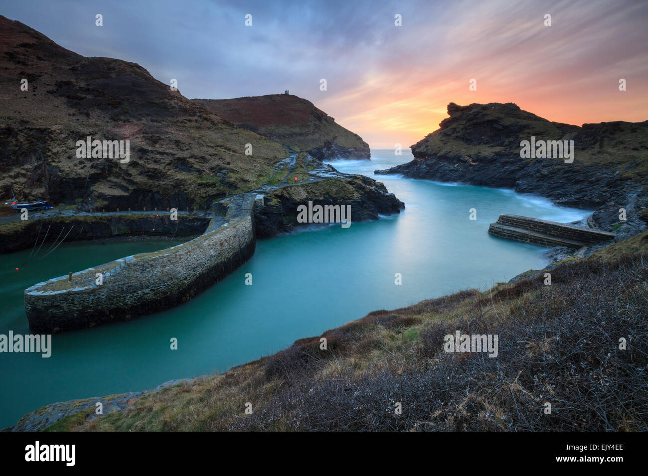 The harbour entrance at Boscastle in North Cornwall captured from the south west coast path, shortly before sunset in March. Stock Photo