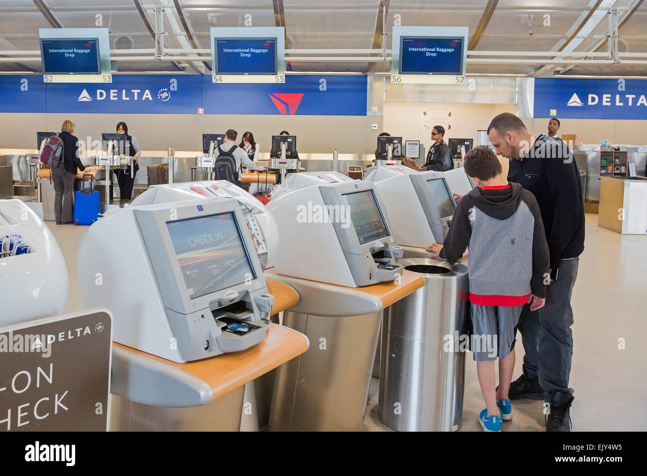 Romulus, Michigan - Passengers use self-service machines to check in for flights on Delta Air Lines at Detroit Metro Airport. Stock Photo