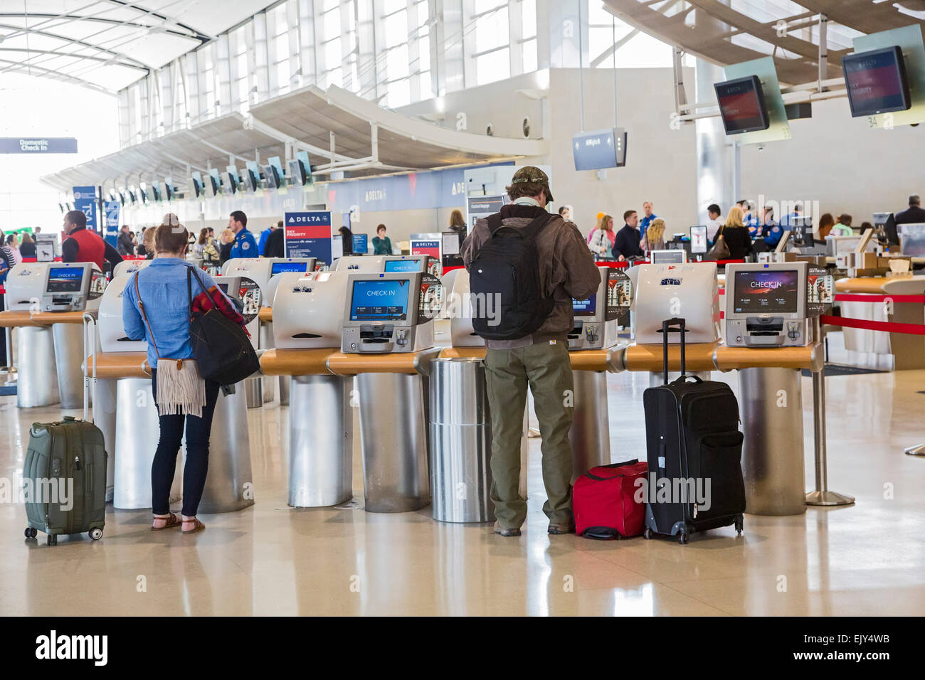 Romulus, Michigan - Passengers use self-service machines to check in for flights on Delta Air Lines at Detroit Metro Airport. Stock Photo