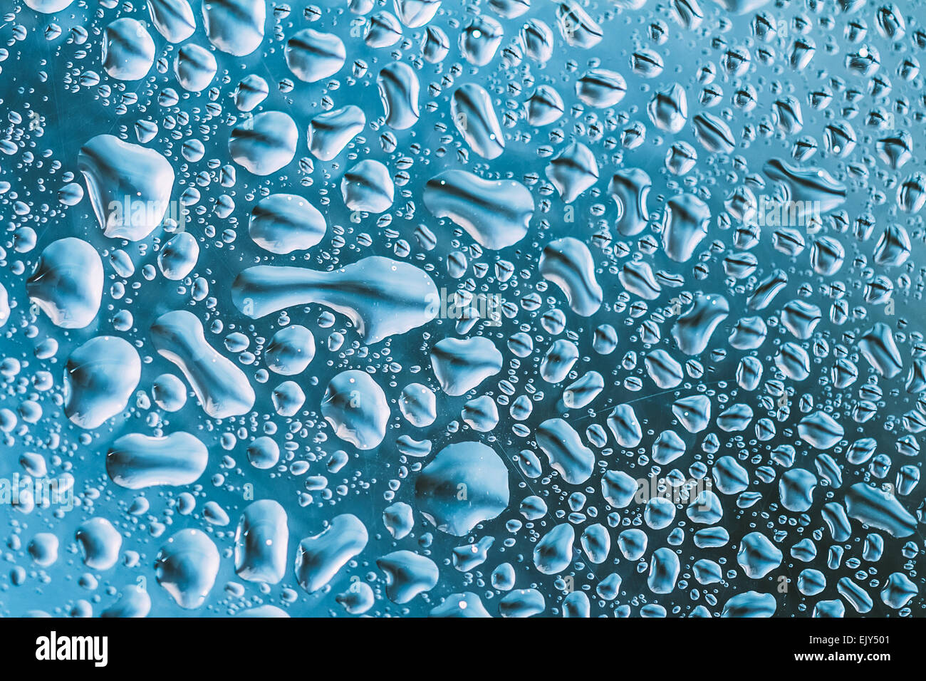 Water Drops Of Rain On Blue Glass Background Stock Photo - Alamy