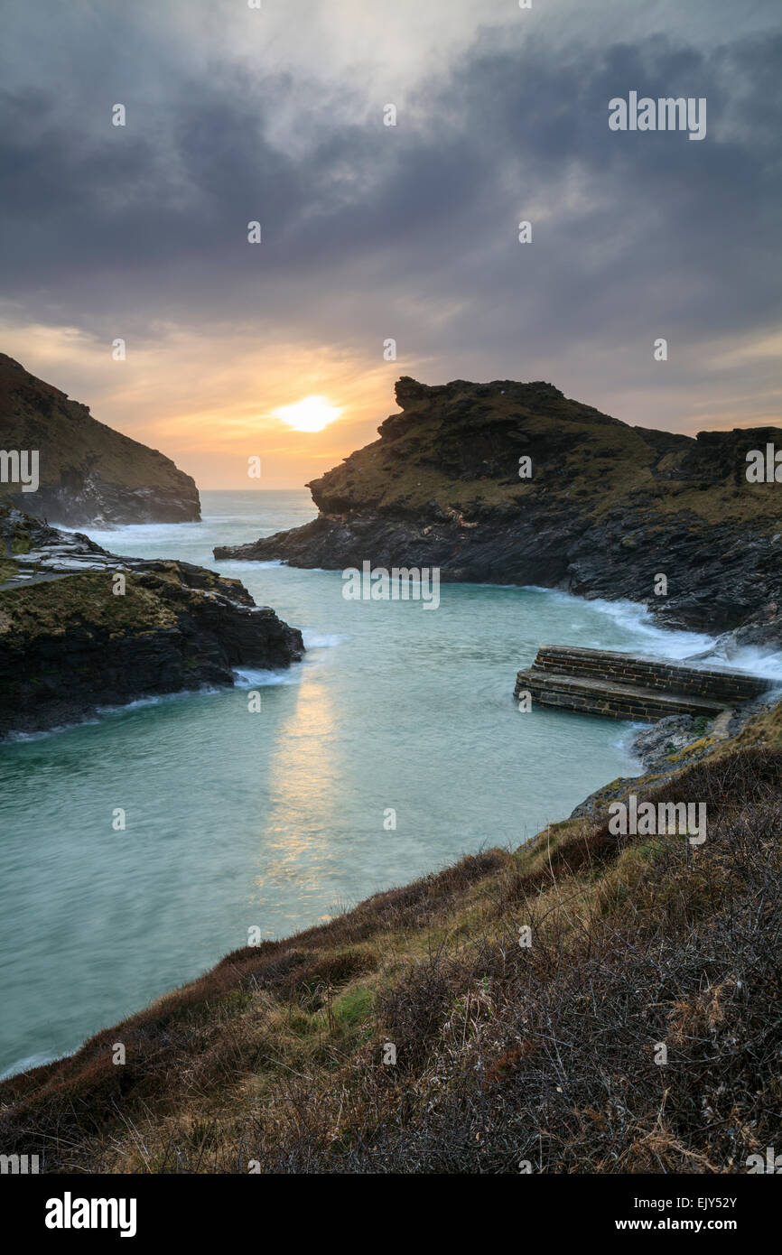 The harbour entrance at Boscastle in North Cornwall captured from the south west coast path, shortly before sunset in March. Stock Photo