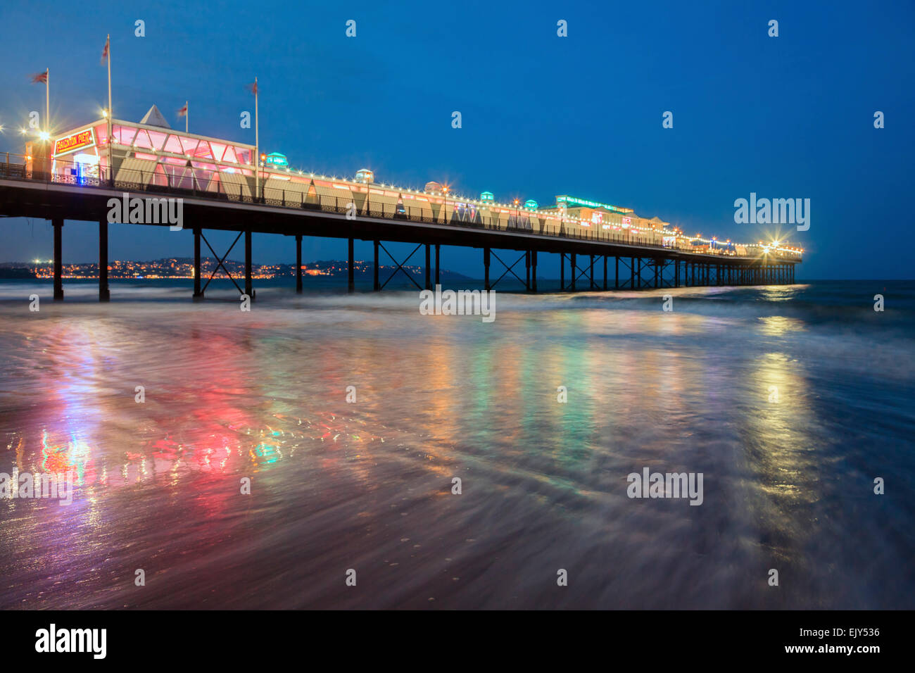 Paignton Pier in Torbay, captured during the hours of twilight. Stock Photo