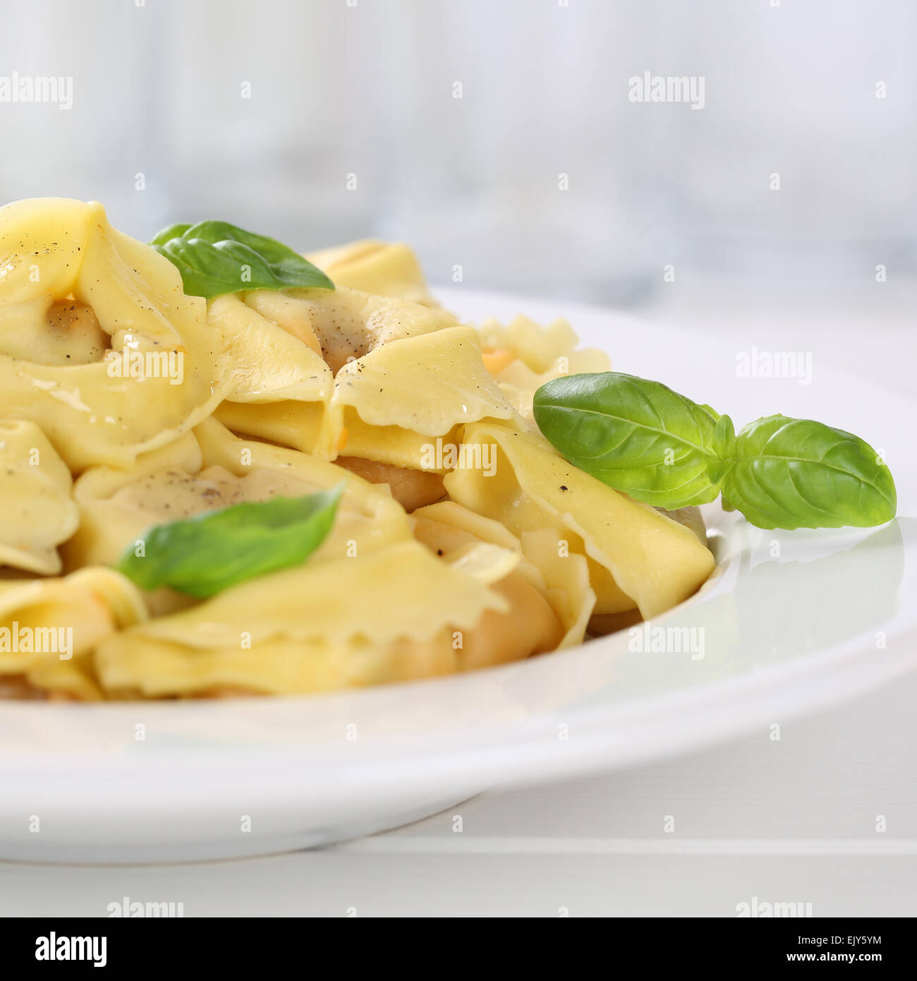 Italian cuisine Tortellini pasta noodles meal with basil on plate Stock