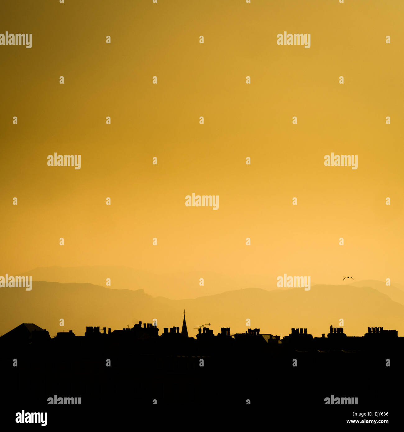Golden light: The silhouette of rooftops at dusk, Llandudno, Conwy, North Wales UK Stock Photo