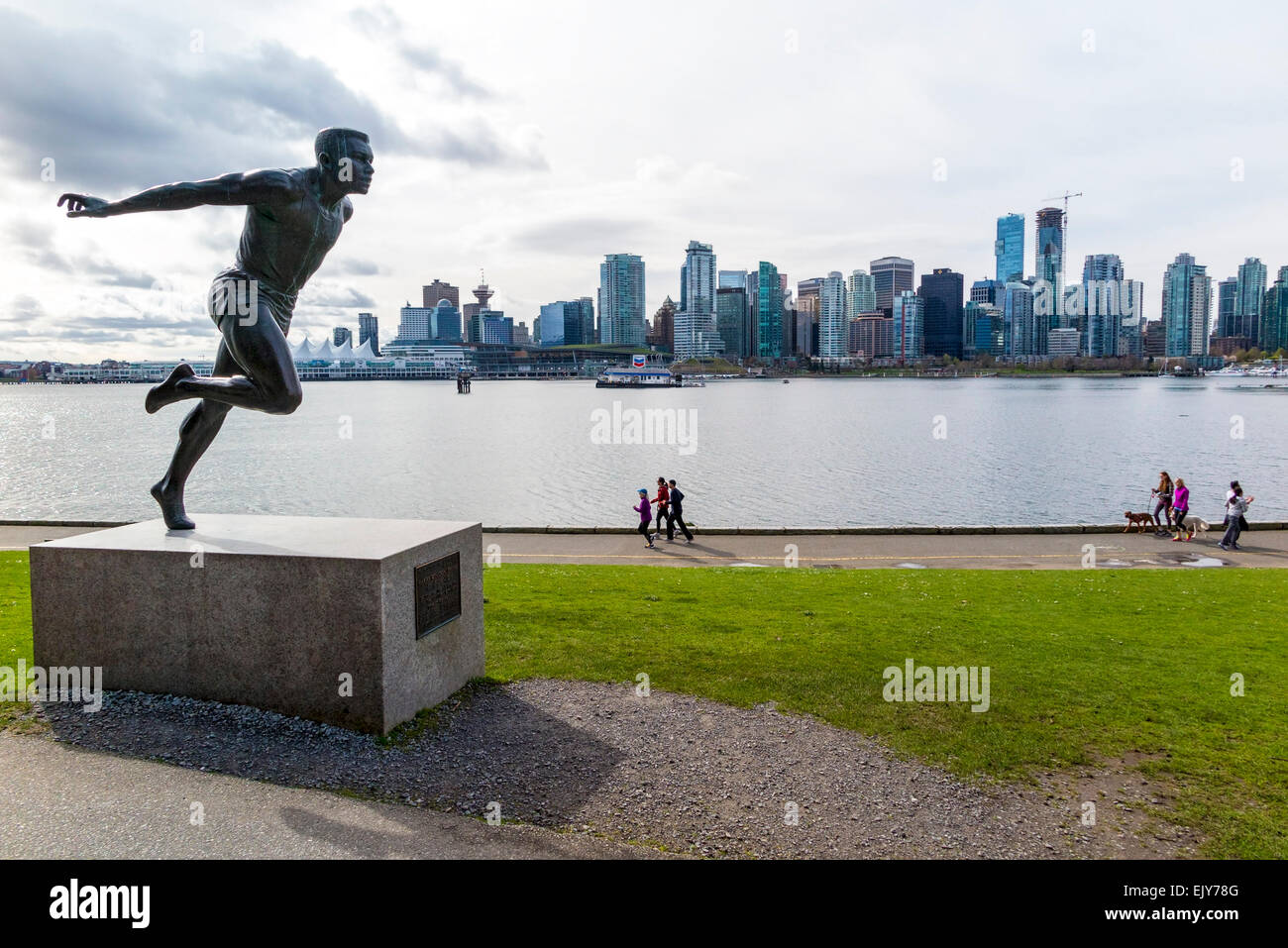 People running and jogging alone the seawall of Stanley Park, Vancouver, British Columbia, Canada. Stock Photo
