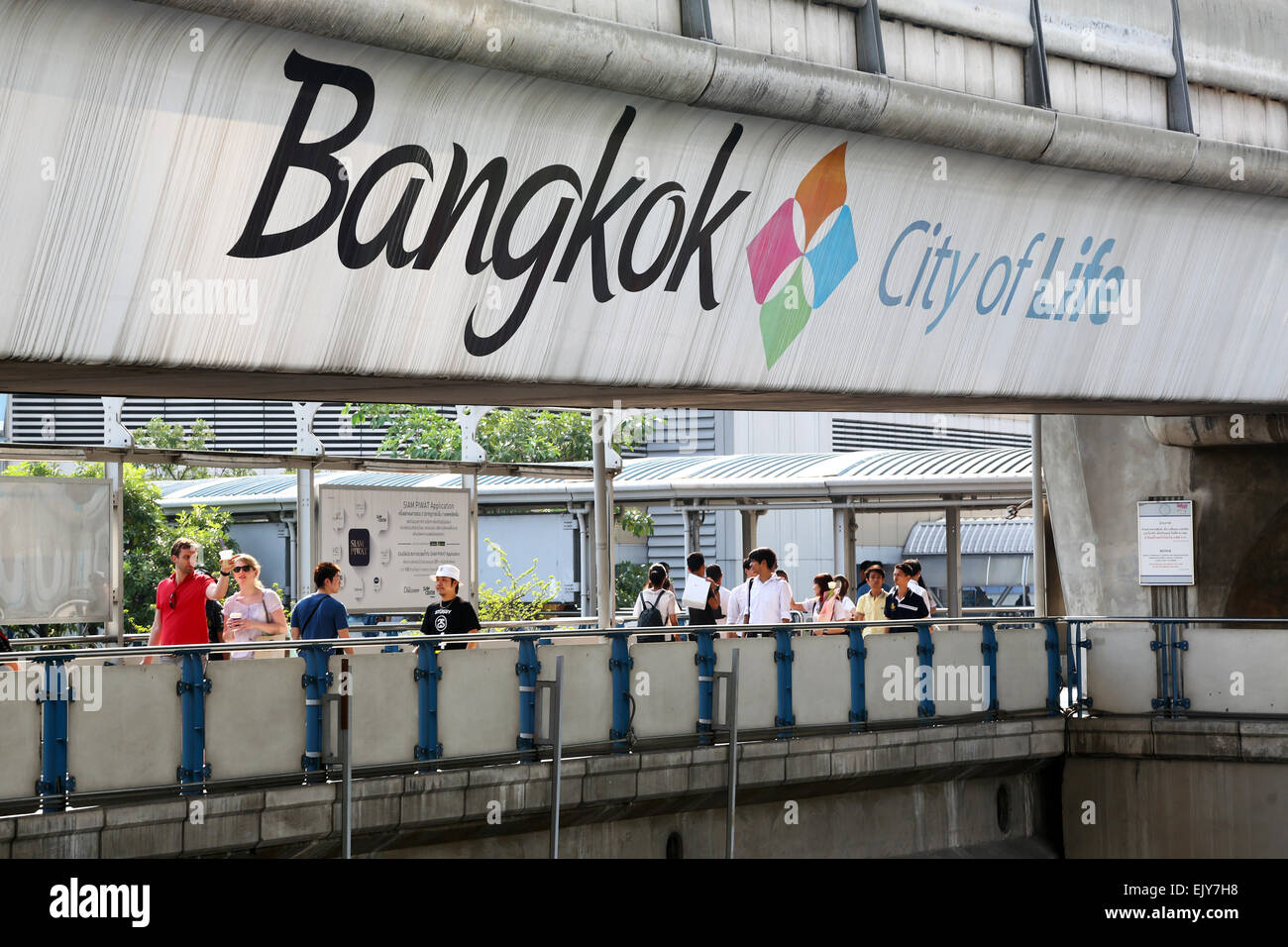 People crossing a pedestrian walkway in Bangkok, Thailand Stock Photo
