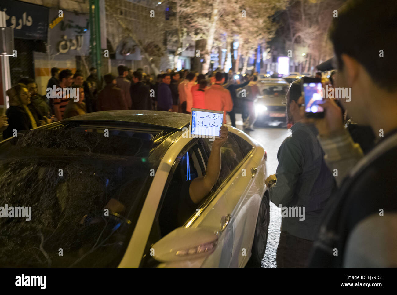 Tehran, Iran. 2nd Apr, 2015. April 3, 2015 - Tehran, Iran - An Iranian man holds a tablet with a Persian script that said, Down with concerns, as he celebrate after Iran's nuclear agreement with world powers in Lausanne, in northern Tehran.  Credit:  Morteza Nikoubazl/ZUMA Wire/Alamy Live News Stock Photo