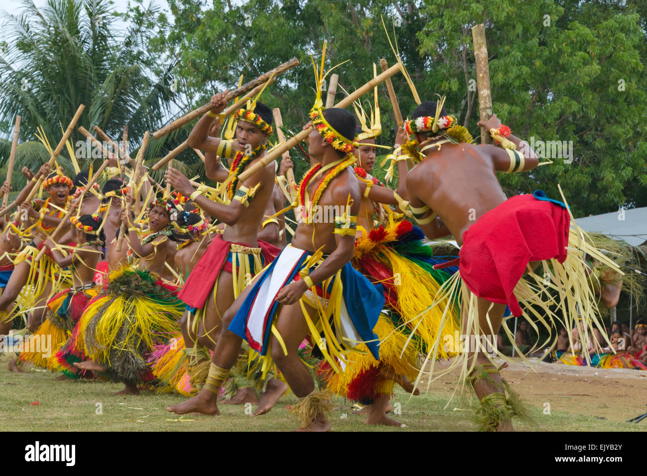 Boys and girls in traditional clothing dancing with bamboo pole at Yap ...