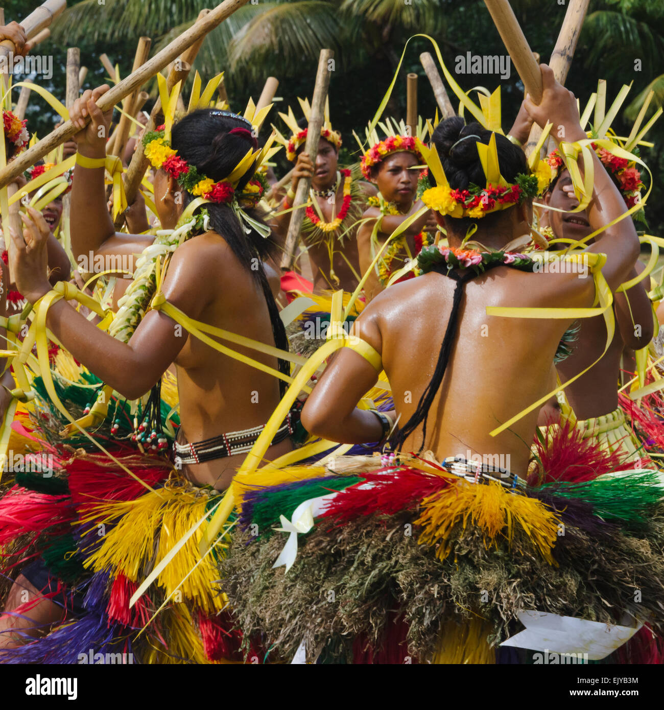 Yapese girls in traditional clothing dancing with bamboo pole at Yap Day Festival, Yap Island, Federated States of Micronesia Stock Photo