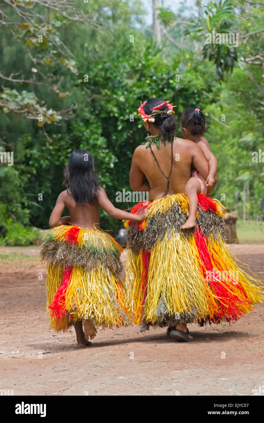 Yapese woman in traditional clothing carrying little girl at Yap Day Festival, Yap Island, Federated States of Micronesia Stock Photo