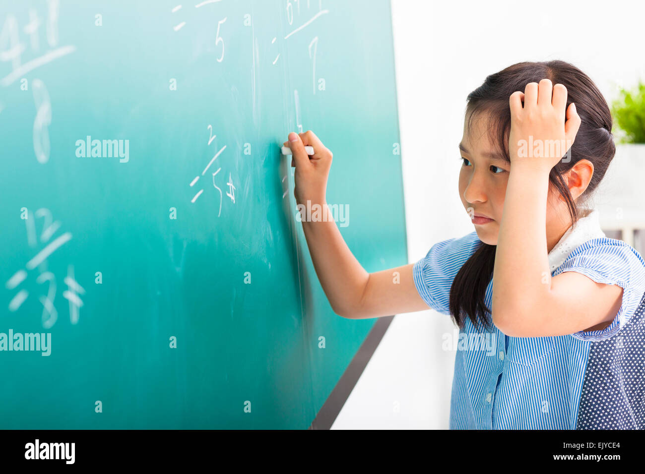 school girl doing math problems on the chalkboard Stock Photo
