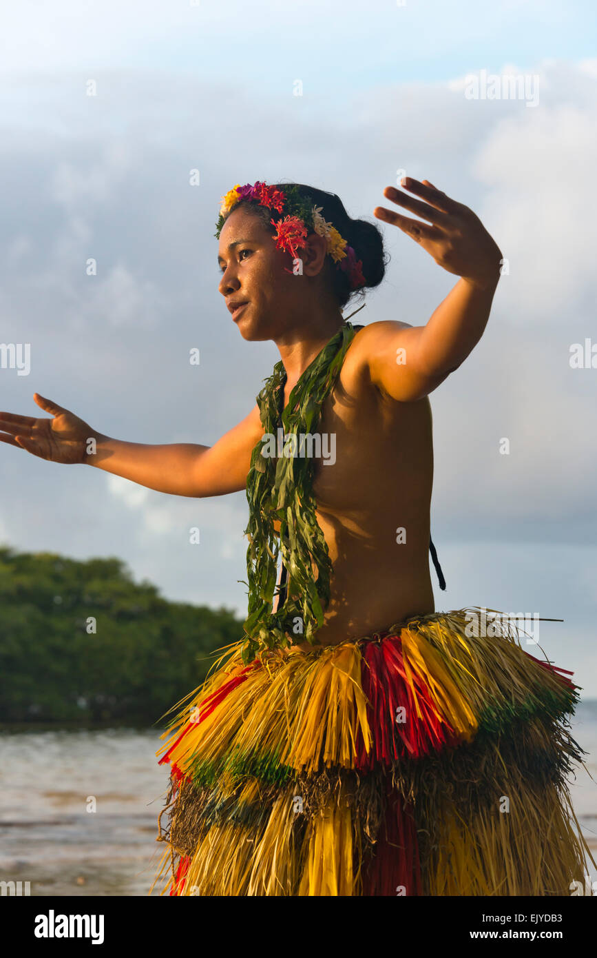 Yapese girl in grass skirt dancing by the ocean, Yap Island, Federated