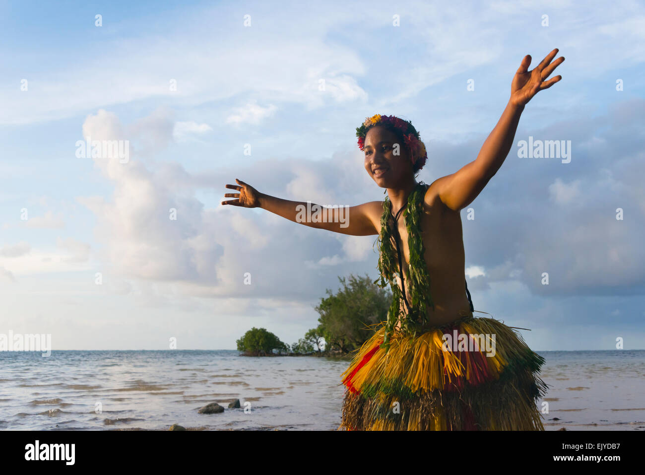 Yapese girl in grass skirt dancing by the ocean, Yap Island, Federated