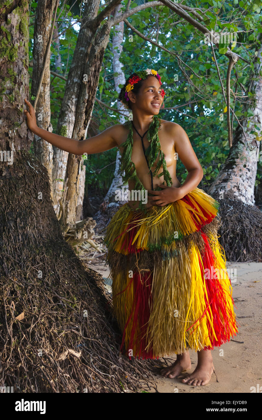 Yapese girl in grass skirt standing by a tree, Yap Island, Federated States of Micronesia Stock Photo