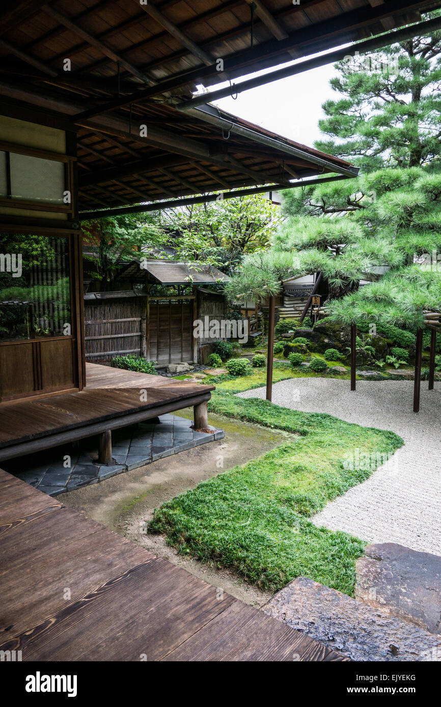 View of a traditional Japanese garden with wooden veranda and raked gravel in Kyoto, Japan Stock Photo