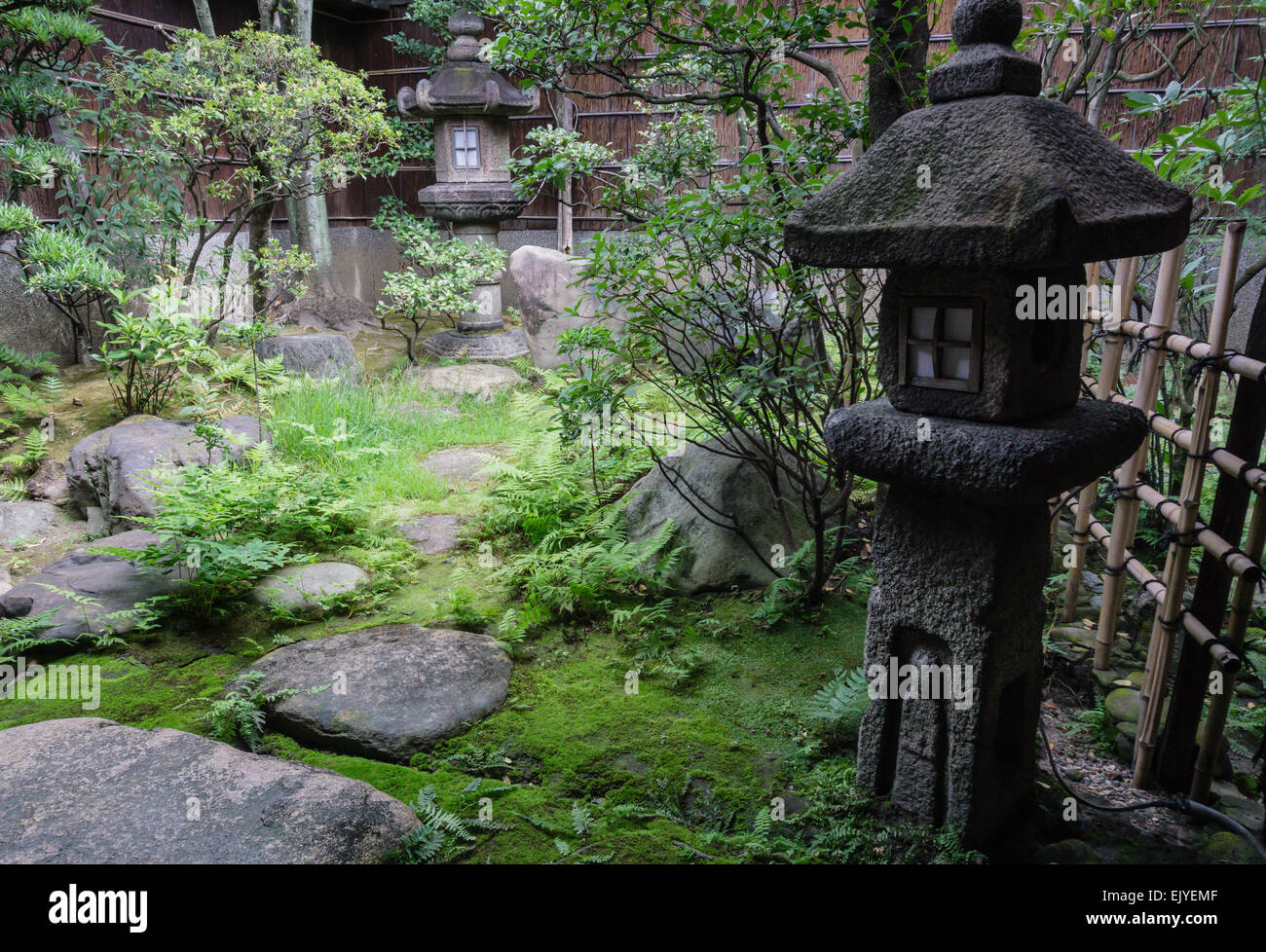 View of a traditional Japanese garden with old lantern in Kyoto, Japan Stock Photo