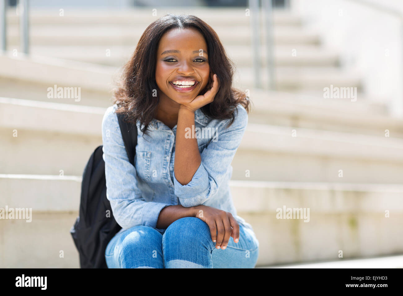 happy young African college girl sitting outdoors Stock Photo - Alamy