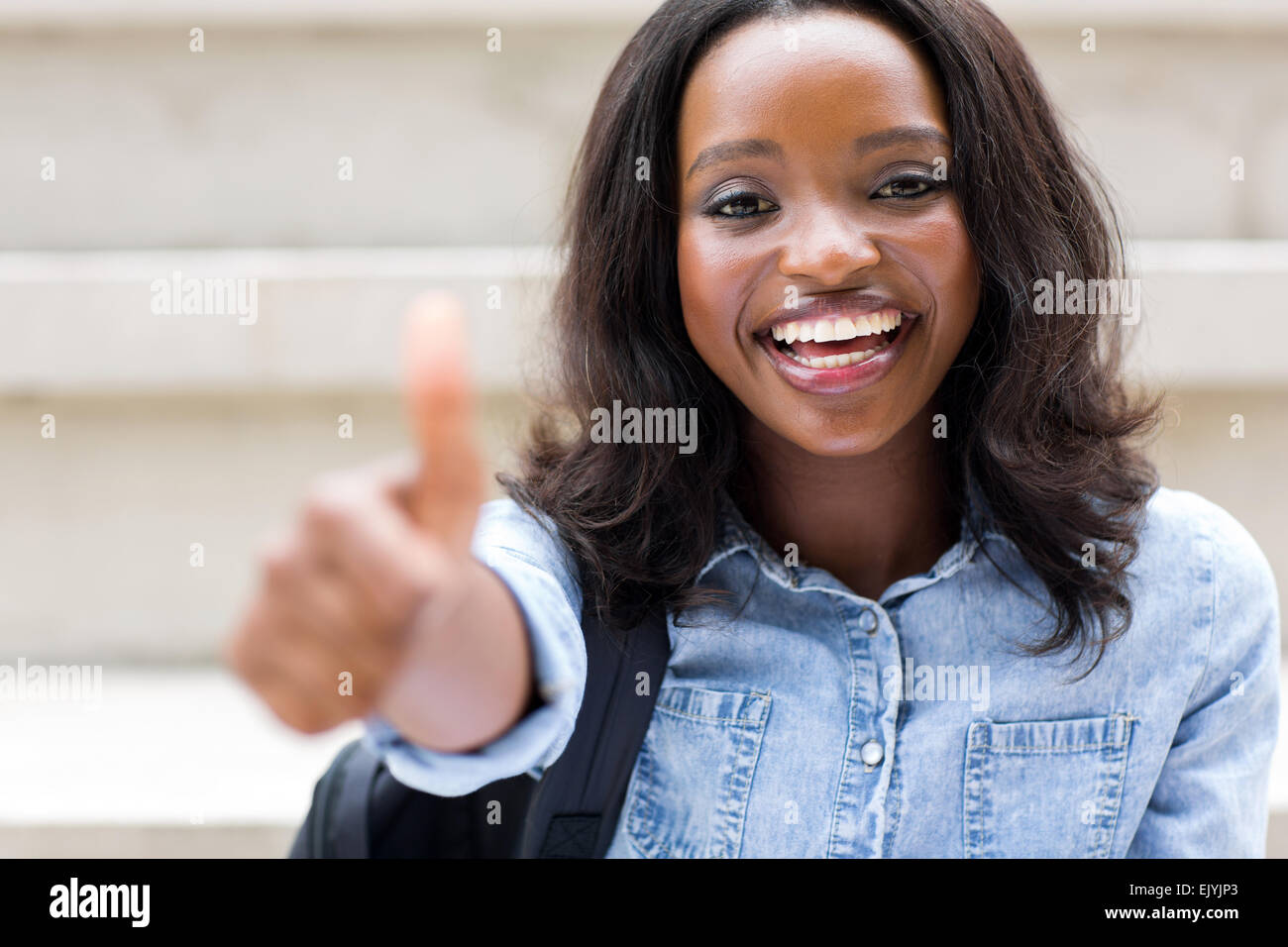 happy African American college girl with thumb up Stock Photo - Alamy