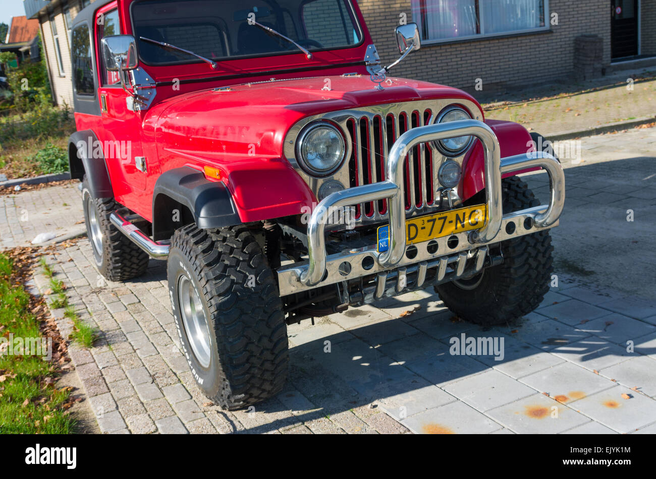 red jeep wrangler car with chrome bull bar. The production of the Wrangler began in 1987 and was succeeded in 1997 and 2007 by a Stock Photo