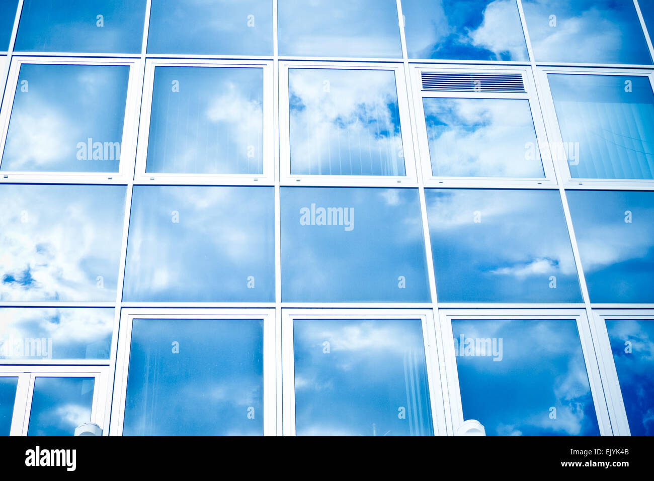 glass windows with cloudy sky reflected Stock Photo