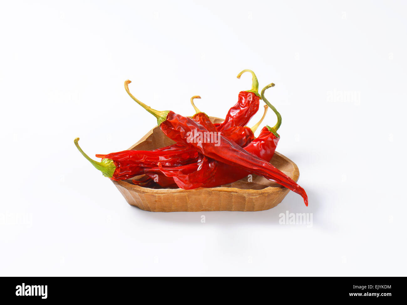Dried Red Chili Peppers in wooden bowl Stock Photo