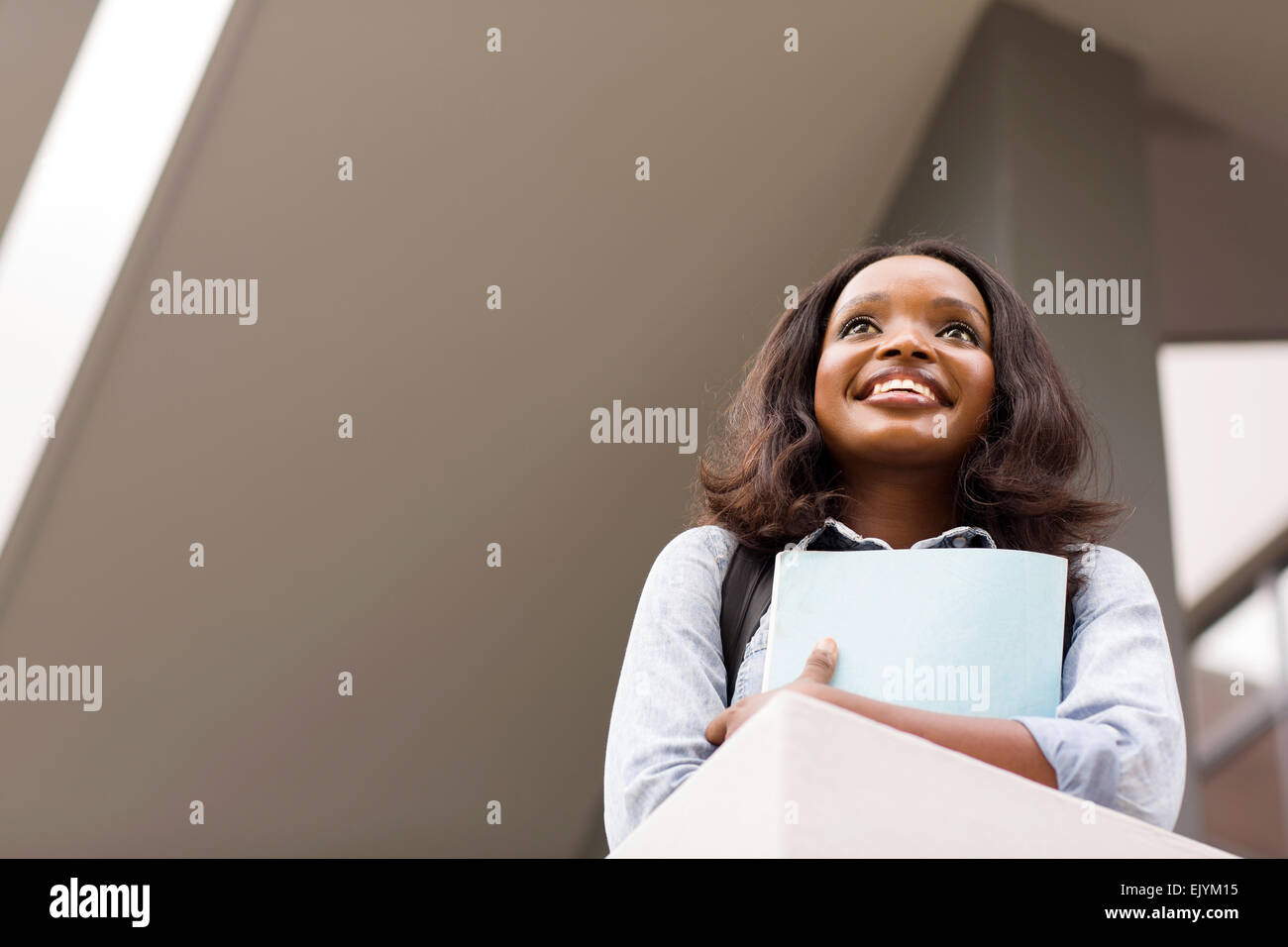 beautiful African female college student looking up Stock Photo - Alamy