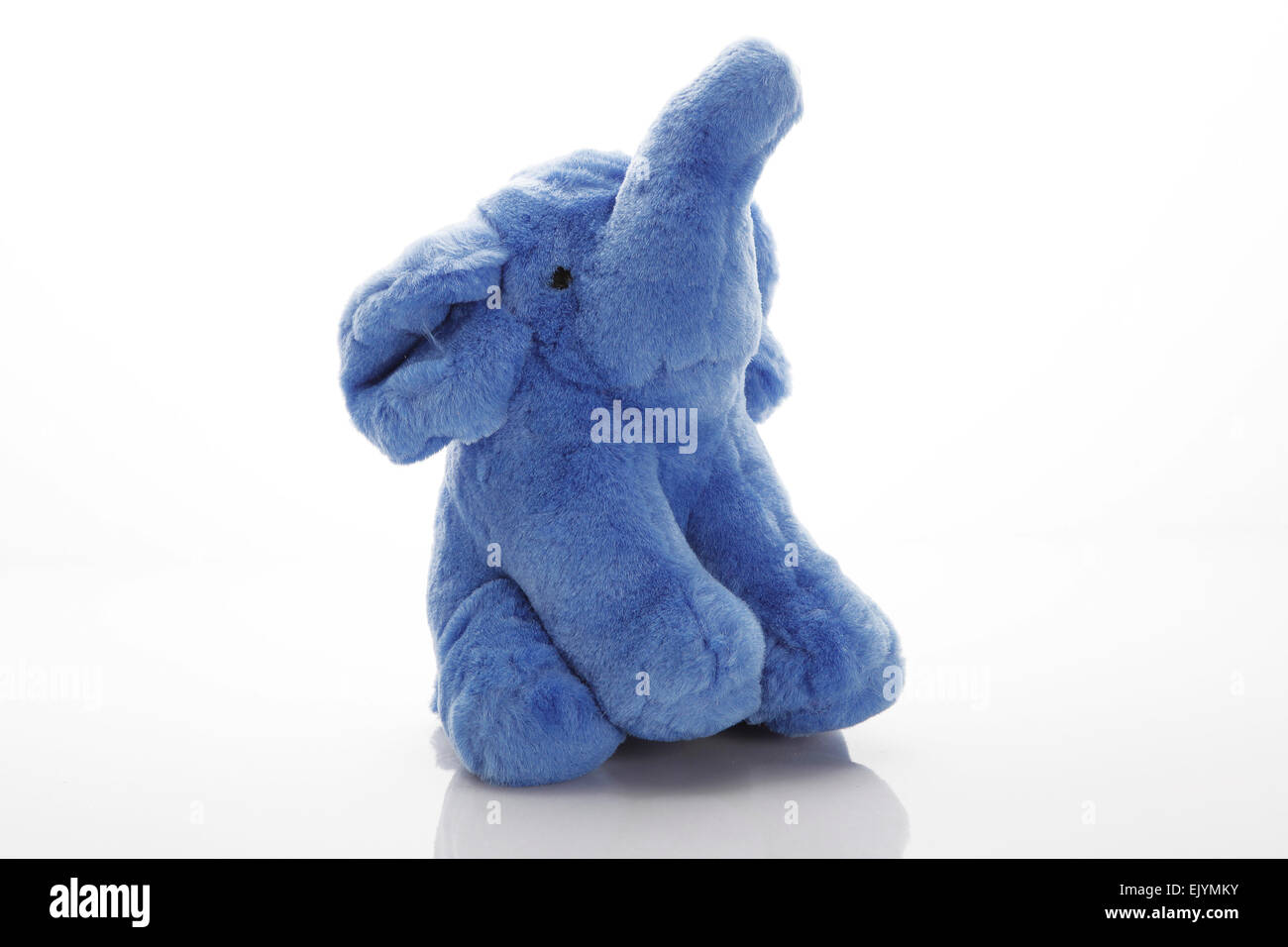 a stuffed teddy bear toy in the shape of an elephant, for kids to play with , shot on white plexi background Stock Photo