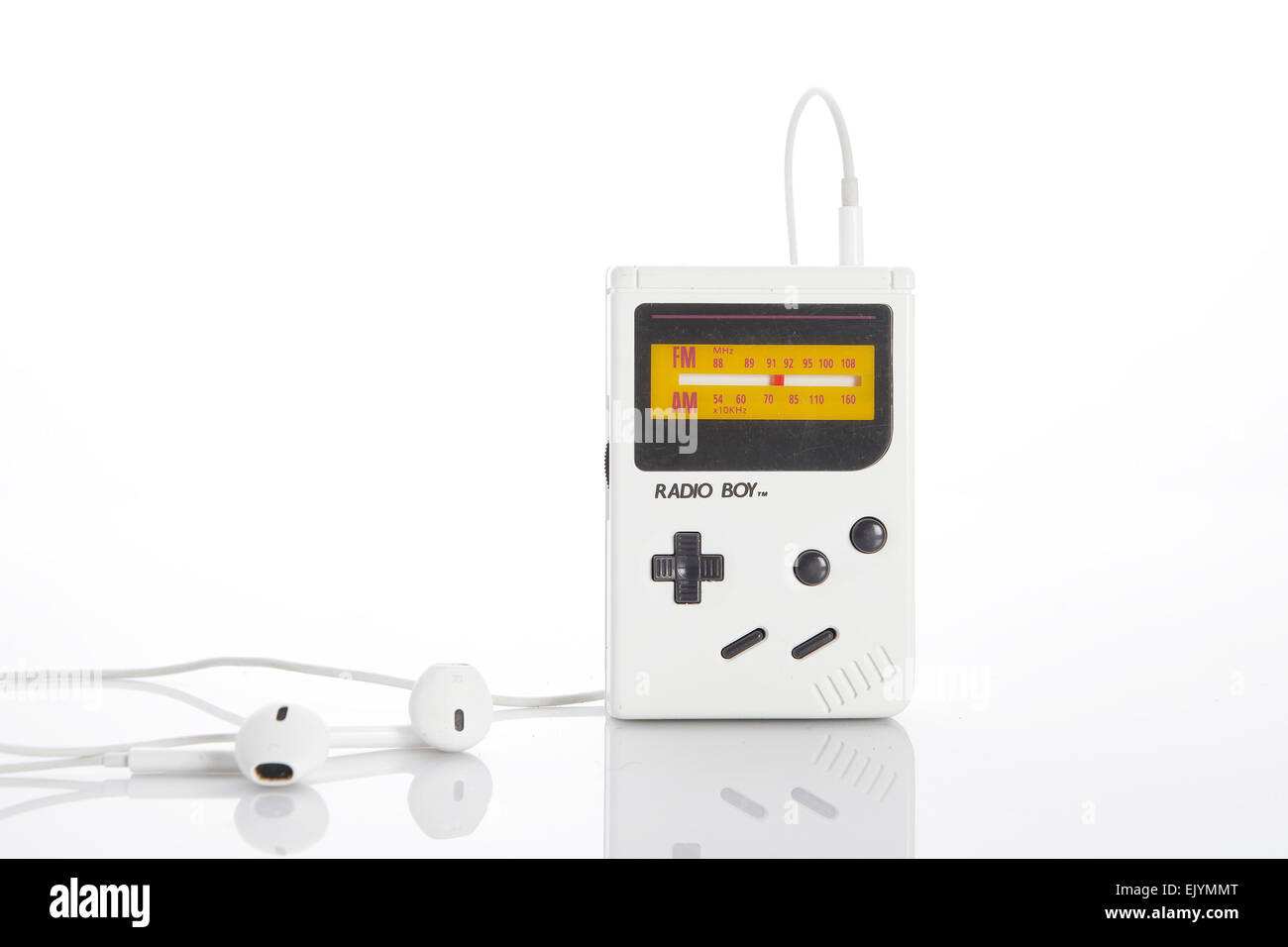 And old, vintage, white gameboy radio with white earphones on white background Stock Photo