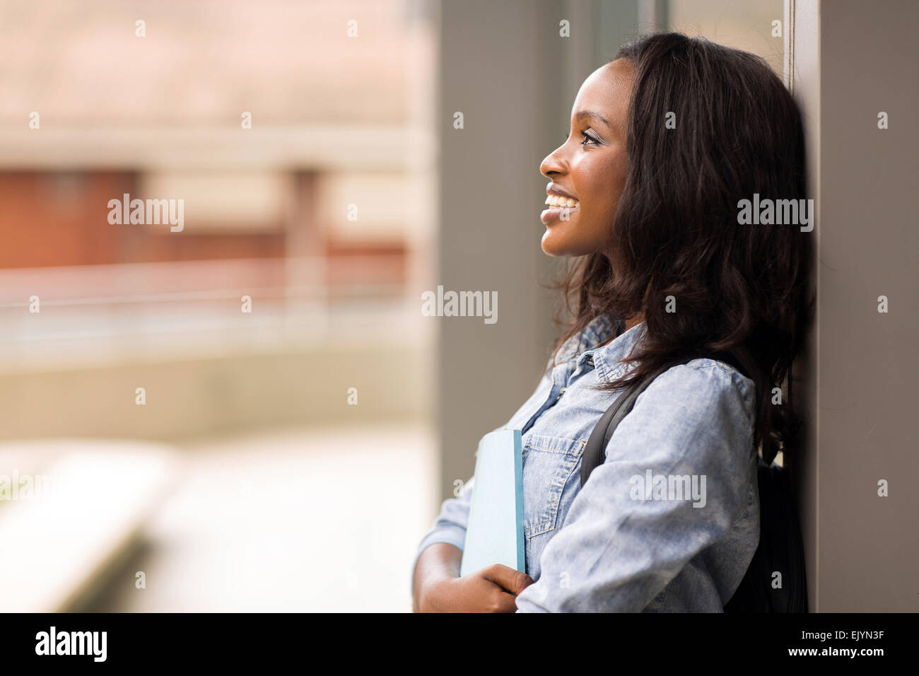 cheerful African American college girl looking up Stock Photo - Alamy