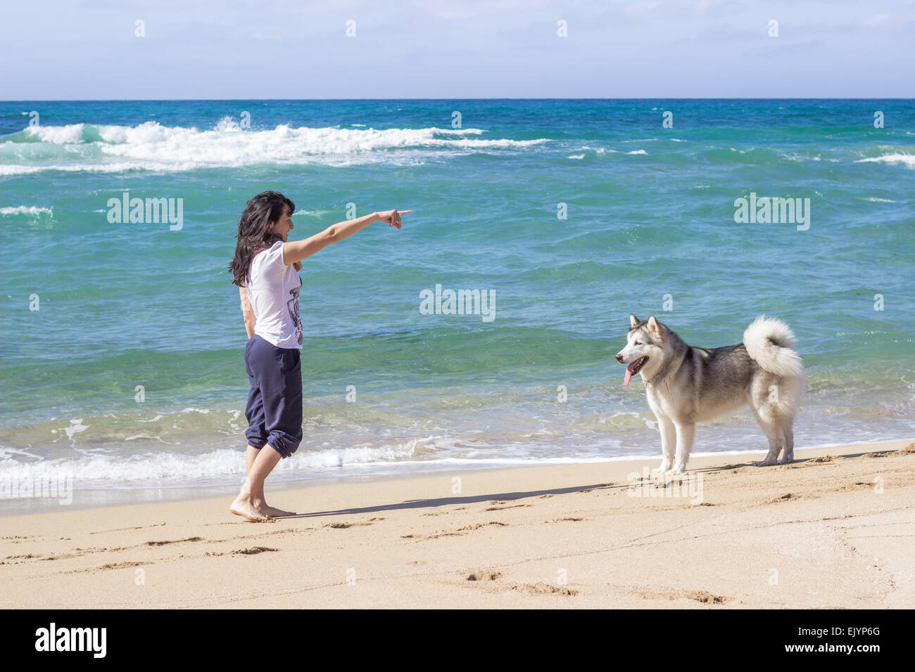 girl woman husky dog beach sea ocean coast Stock Photo