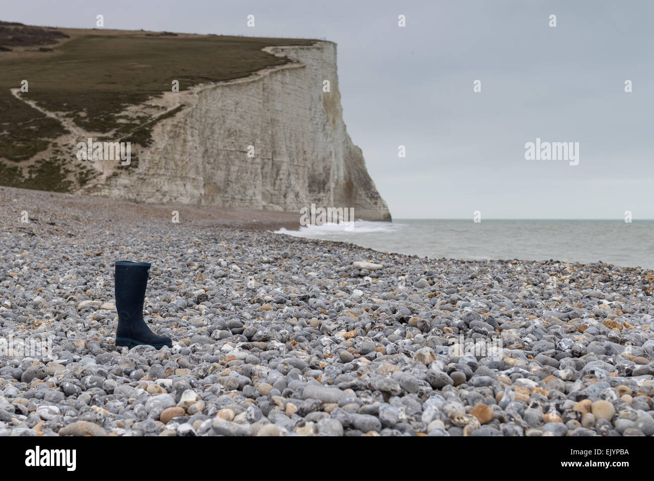 Single wellington boot on a deserted beach Stock Photo - Alamy
