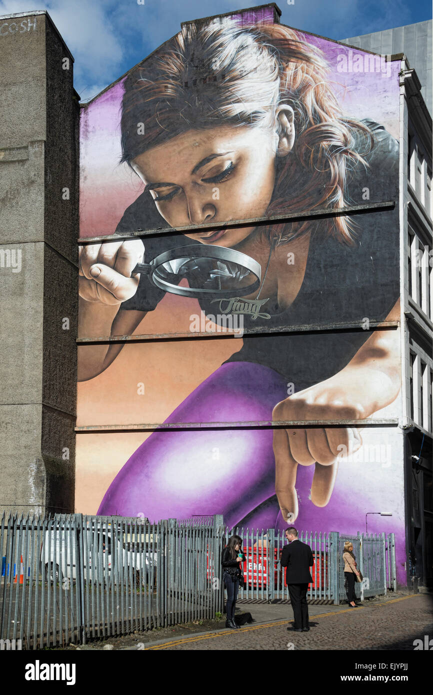 Large street art installation mural showing girl with magnifying