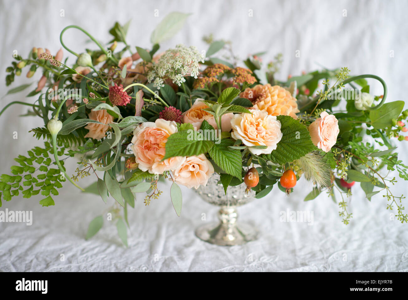 Formal floral arrangement of roses in silver urn Stock Photo