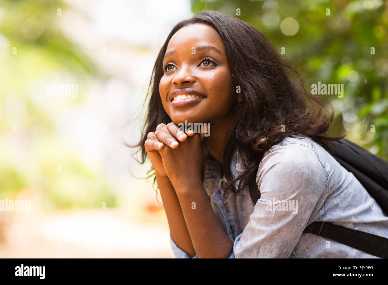 attractive female African college student daydreaming Stock Photo - Alamy