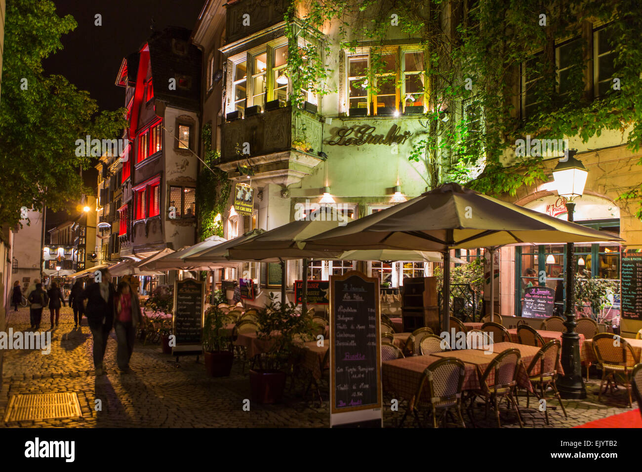 Street restaurant cafe tables and chairs at night, Strasbourg, France Stock Photo