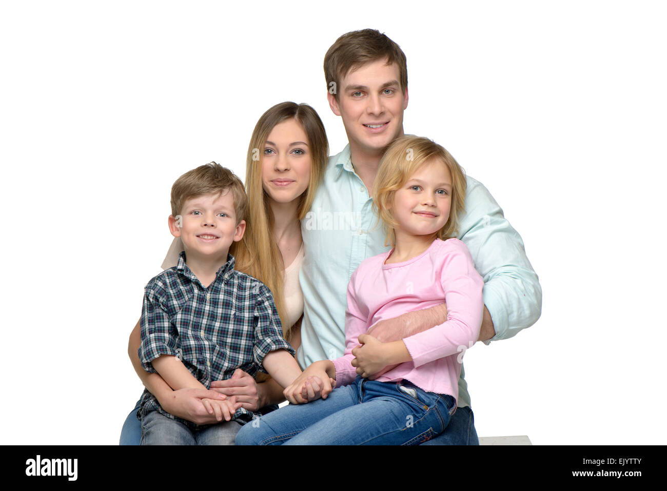 Cheerful young family of four posing Stock Photo - Alamy