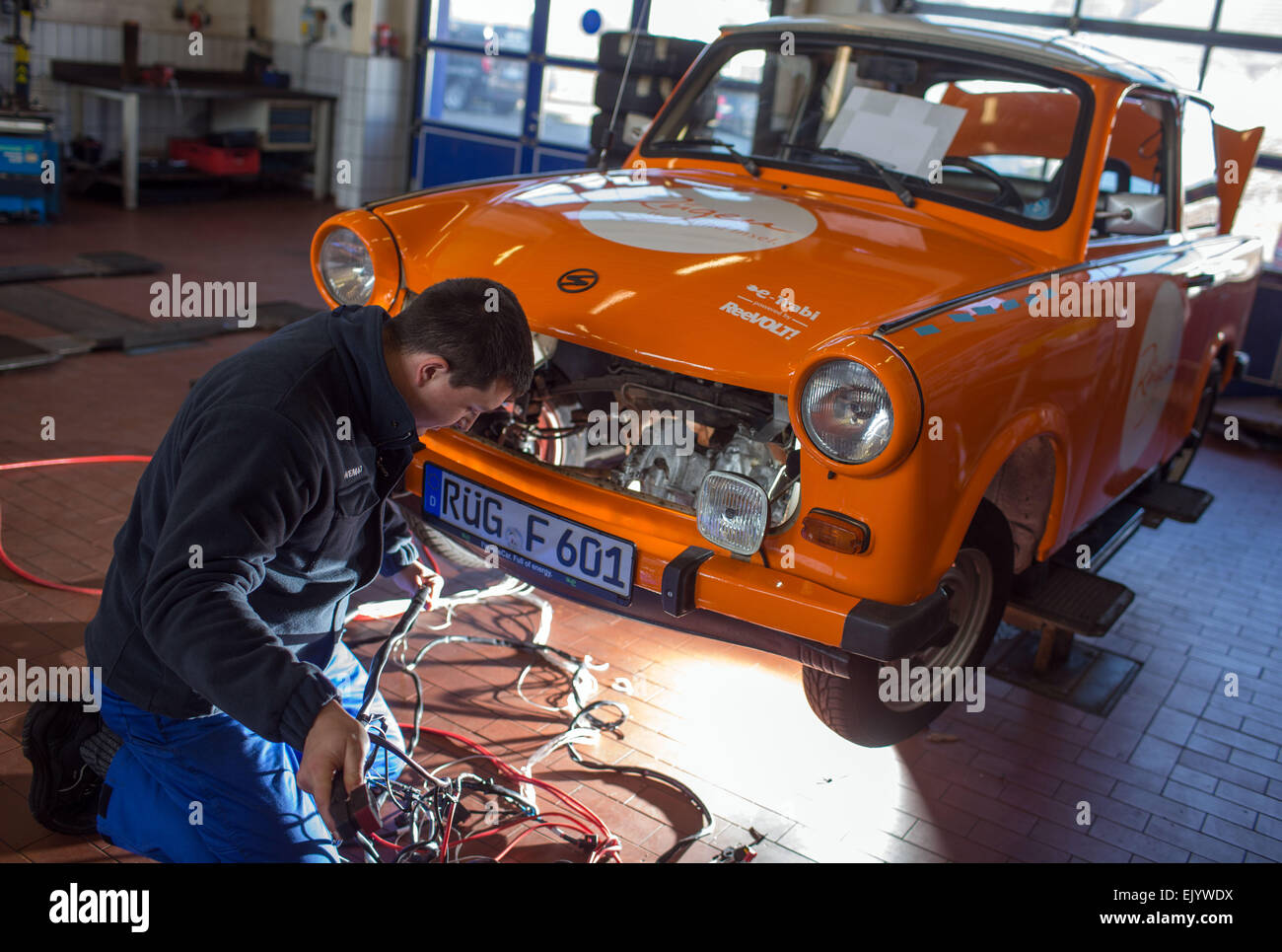 Schwerin, Germany. 12th Mar, 2015. Mechanic Martin Koechele and a Trabant (Trabi) car, which is being converted to run on electricity at a workshop in Schwerin, Germany, 12 March 2015. The E-Trabi is intended to be used for tourist safaris on the island of Ruegen in spring 2015. The firm ReeVolt converts existing vehicles to run on electricity. Photo: Jens Buettner/dpa/Alamy Live News Stock Photo
