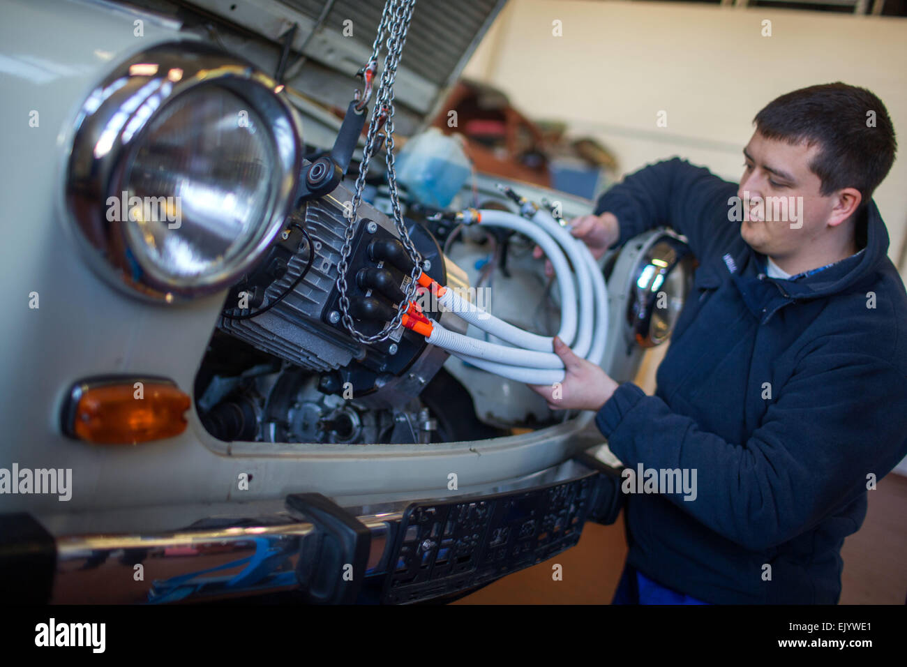 Schwerin, Germany. 12th Mar, 2015. Mechanic Martin Koechele and a Trabant (Trabi) car, which is being converted to run on electricity at a workshop in Schwerin, Germany, 12 March 2015. The E-Trabi is intended to be used for tourist safaris on the island of Ruegen in spring 2015. The firm ReeVolt converts existing vehicles to run on electricity. Photo: Jens Buettner/dpa/Alamy Live News Stock Photo