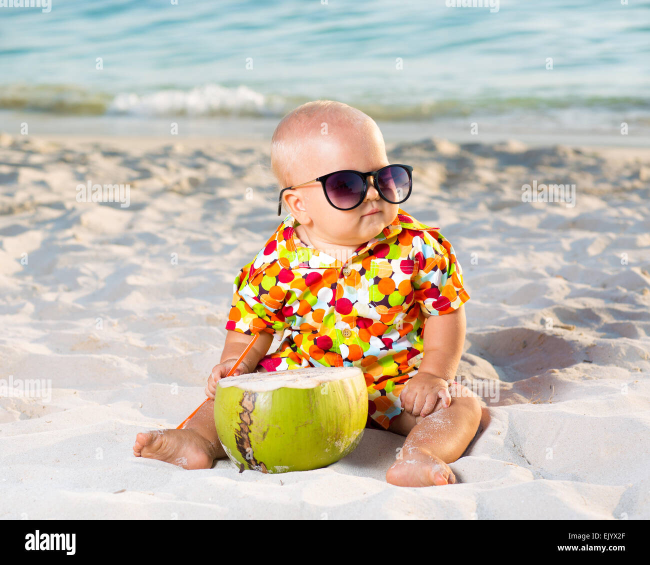 Funny baby wearing sunglasses with coconut Stock Photo Alamy