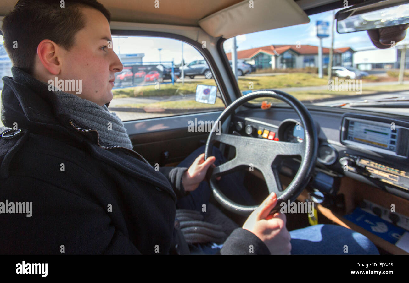 Benjamin Hintz, assistant to ReeVolt's management, takes a Trabant (Trabi) car, which has been converted to run on electricity, for a test drivein Schwerin, Germany, 12 March 2015. The E-Trabi is intended to be used for tourist safaris on the island of Ruegen in spring 2015. The firm ReeVolt converts existing vehicles to run on electricity. Photo: Jens Buettner/dpa Stock Photo