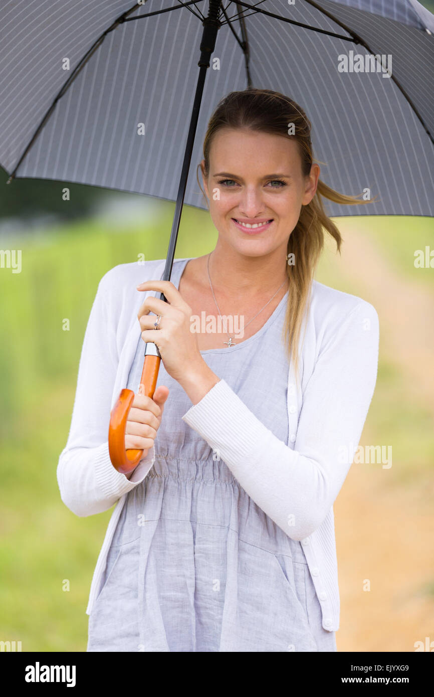 beautiful woman holding up umbrella outdoors Stock Photo