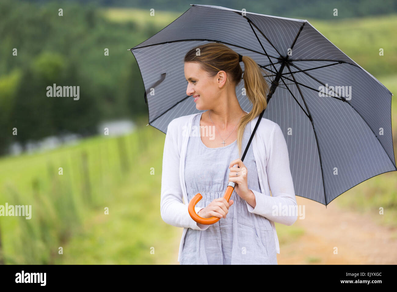 beautiful young woman with an umbrella outdoors Stock Photo