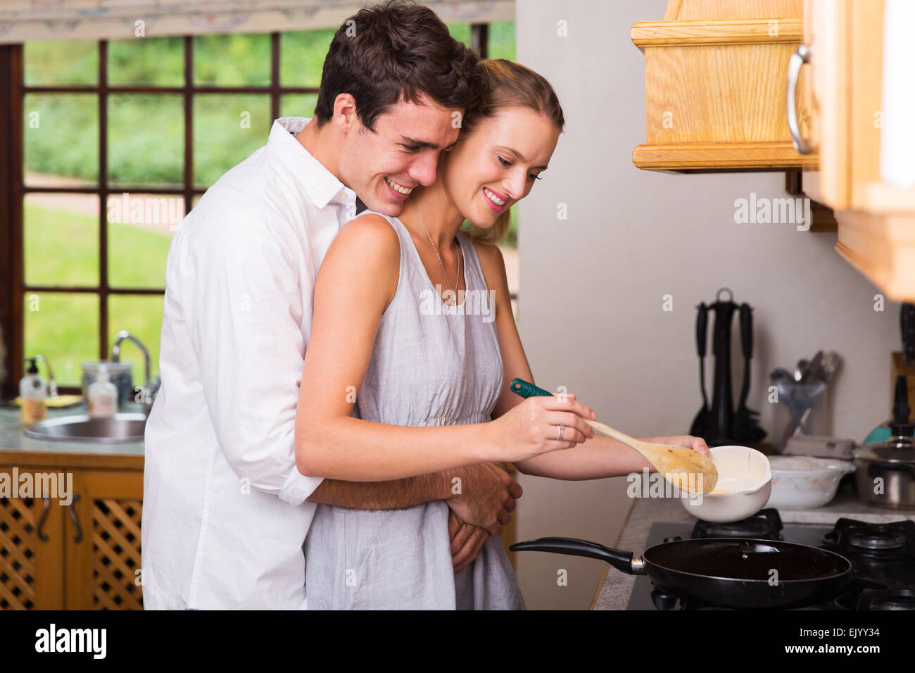 Romantic Young Man Hugging Girlfriend While She Cooks For Breakfast ...