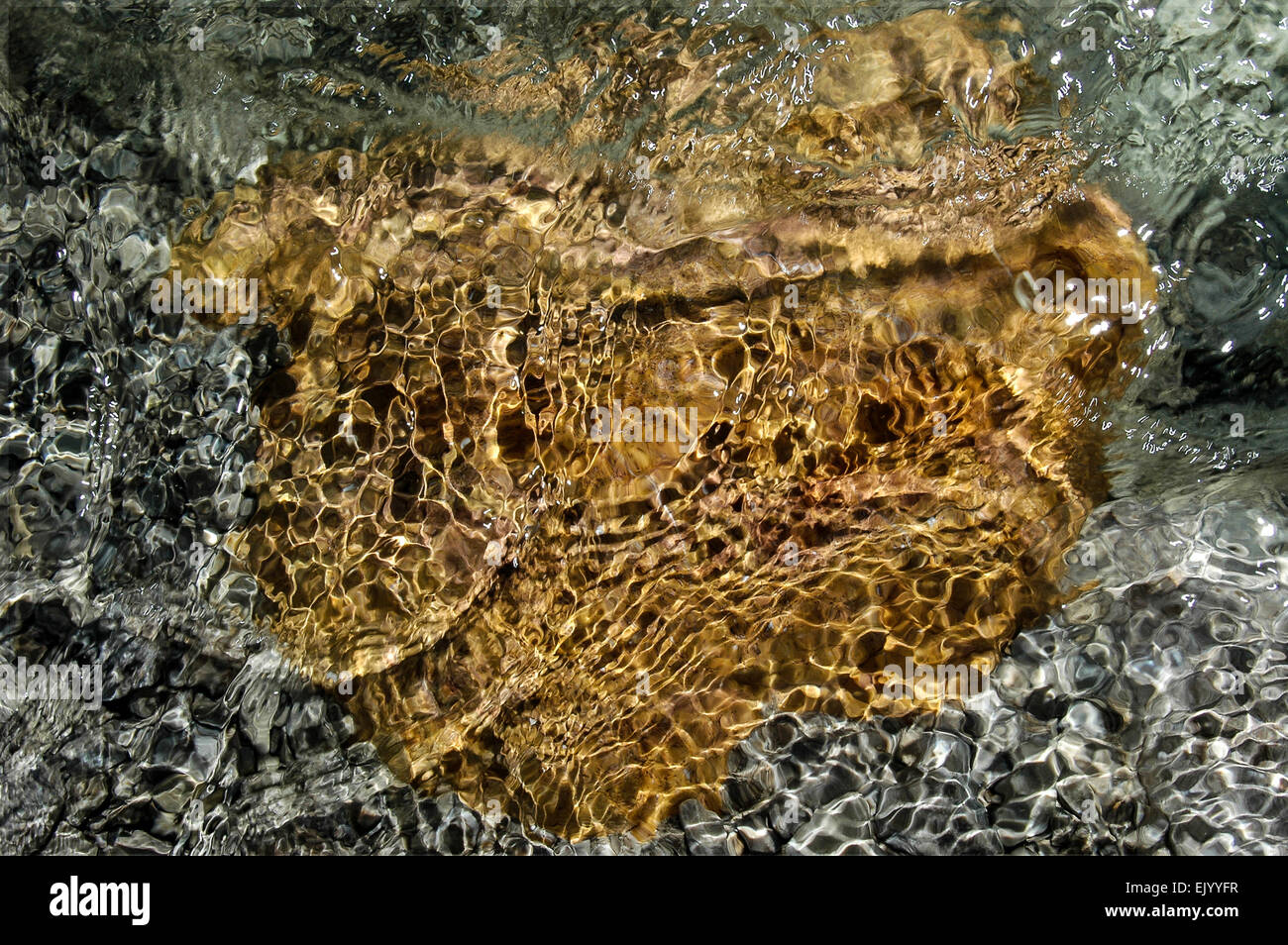 colourful stones in the Weissach river Stock Photo